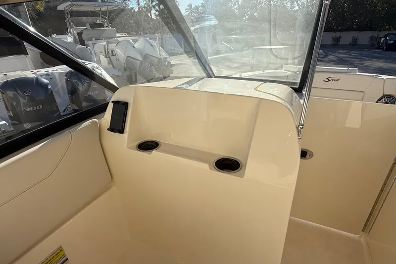 Slide: The Image of Interior view of 2026 Scout 255 Dorado boat with cup holders and windshield. - 16