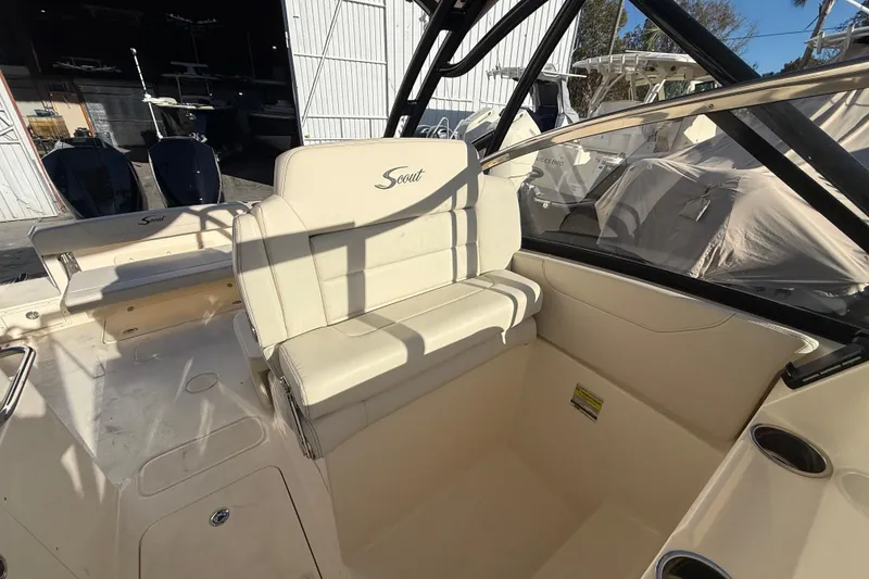 Slide: The Image of 2026 Scout 255 Dorado boat interior with beige seating and cup holders. - 17