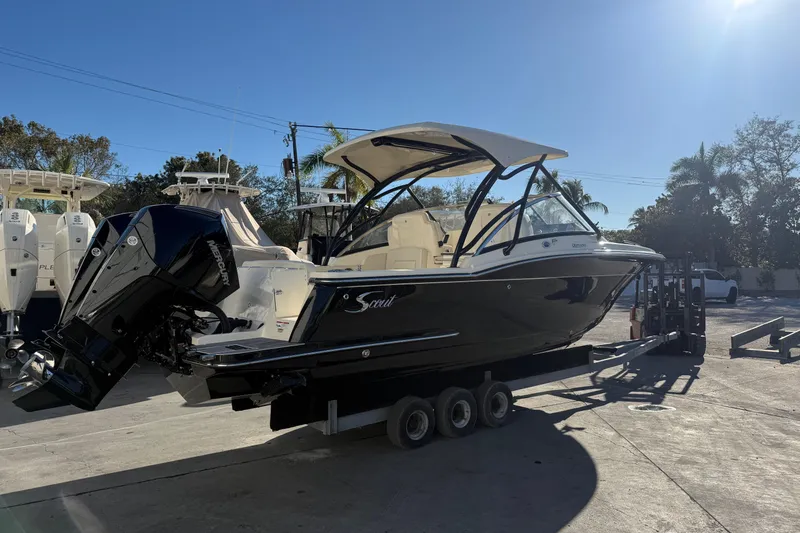 Slide: The Image of 2026 Scout 255 Dorado boat on trailer, sunny day, outdoor display. - 2