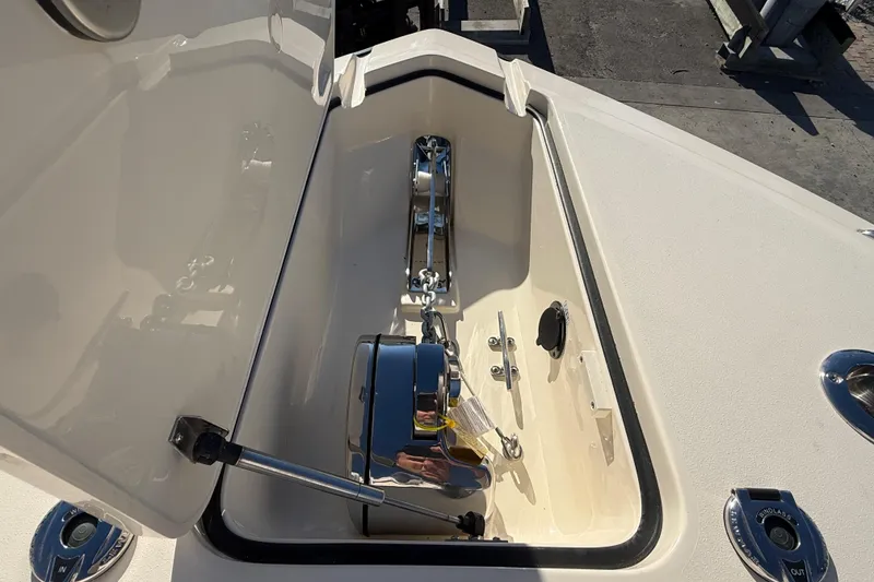 Slide: The Image of Anchor compartment of 2026 Scout 255 Dorado boat, featuring stainless steel hardware. - 20