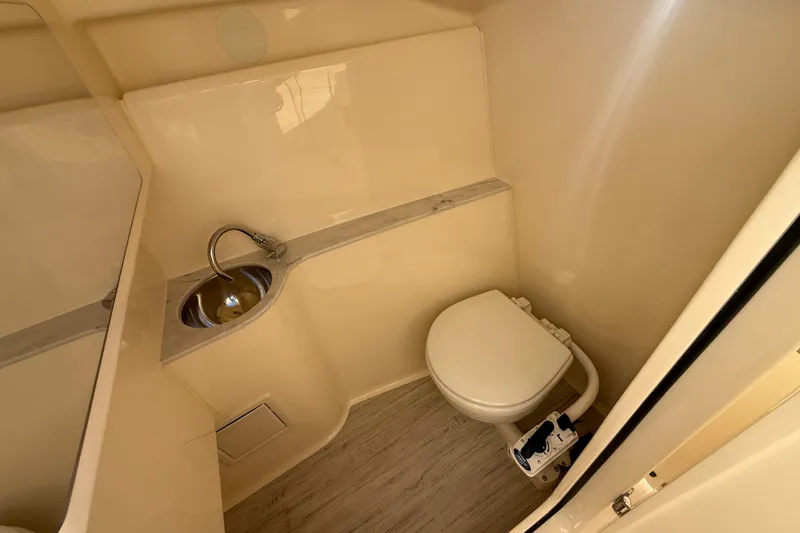 Slide: The Image of 2026 Scout 255 Dorado boat bathroom with sink and toilet, featuring modern design. - 23