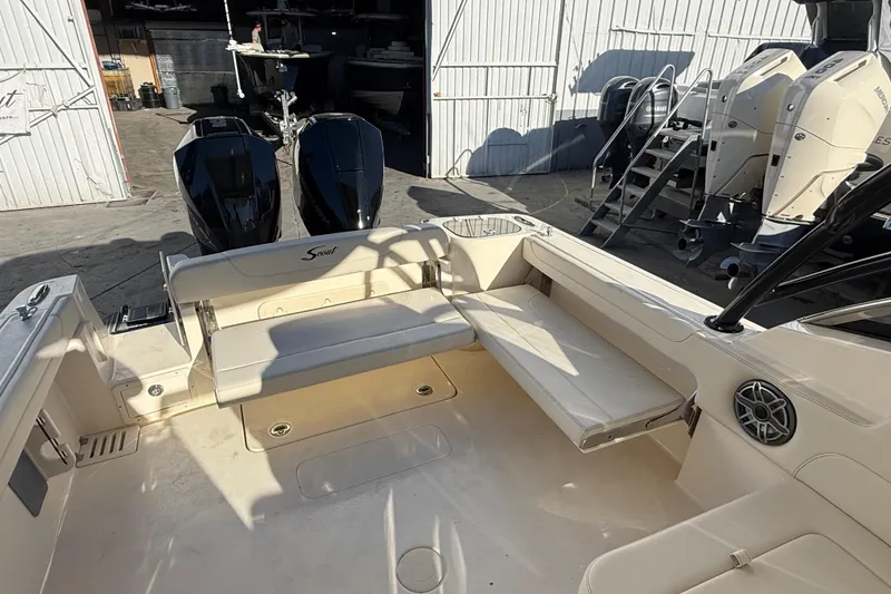 Slide: The Image of 2026 Scout 255 Dorado boat interior with seating and dual outboard motors. - 9