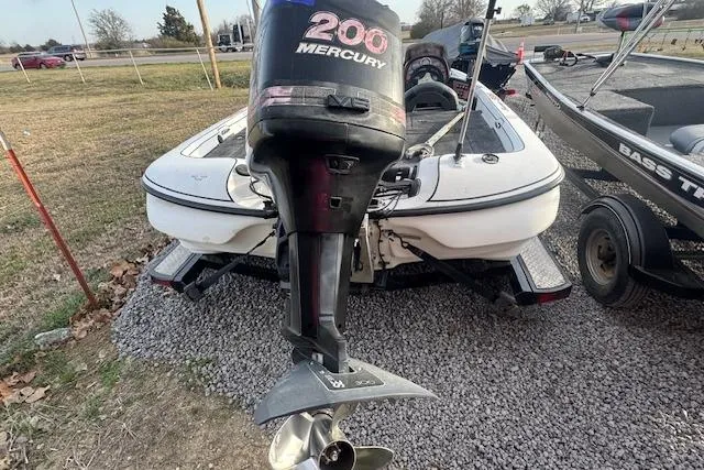 Slide: The Image of 1999 Nitro 896 Savage boat with 200 Mercury outboard motor on gravel. - 3