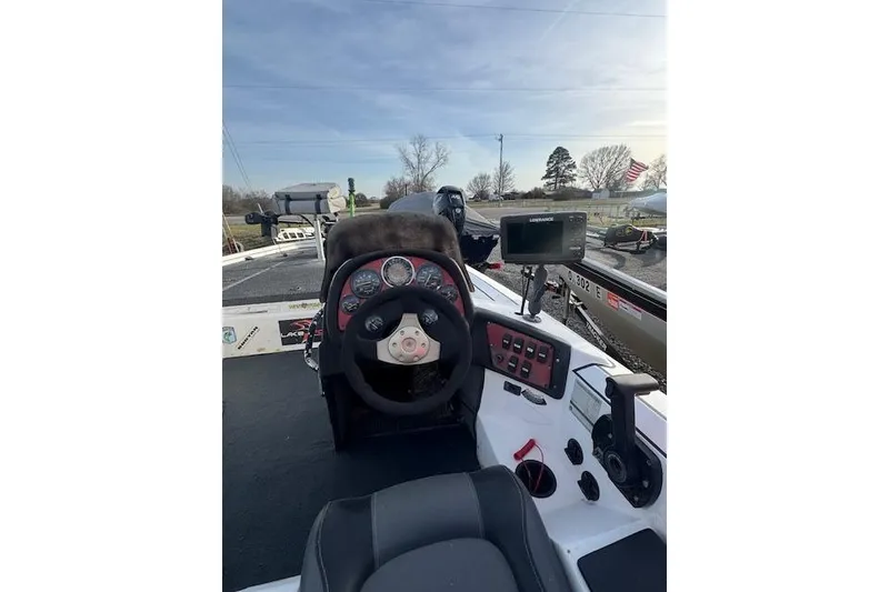 Slide: The Image of 1999 Nitro 896 Savage boat dashboard with steering wheel and navigation equipment. - 4