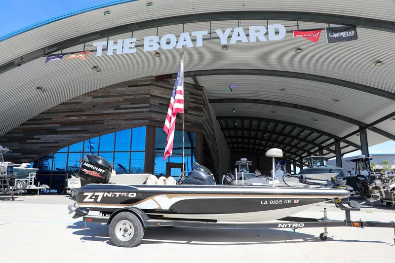 Slide: The Image of 2013 Nitro Z-7 boat displayed at The Boat Yard with American flag. - 10