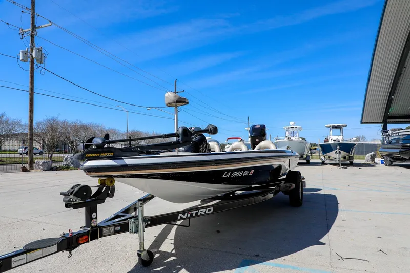 Slide: The Image of 2013 Nitro Z-7 boat on trailer under clear blue sky at marina. - 13