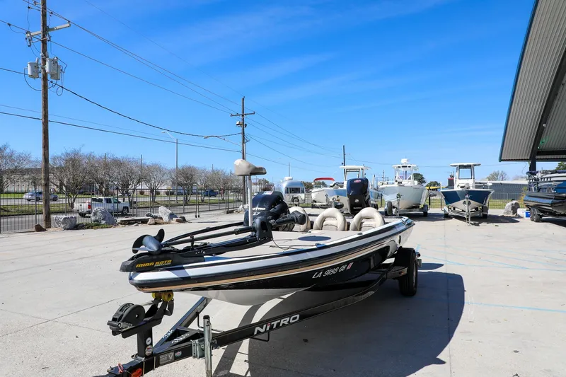 Slide: The Image of 2013 Nitro Z-7 boat on trailer in outdoor lot under clear blue sky. - 14