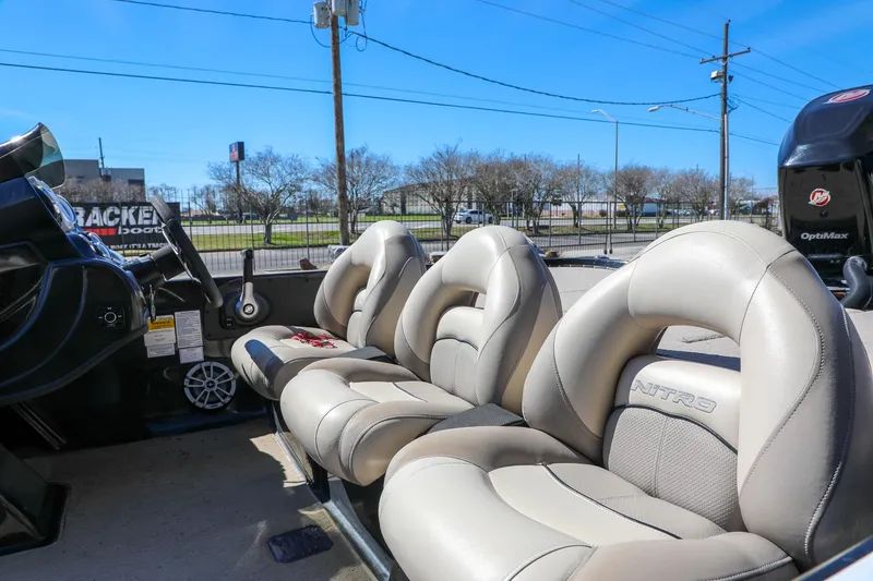 Slide: The Image of 2013 Nitro Z-7 boat interior with beige seats and steering wheel. - 3