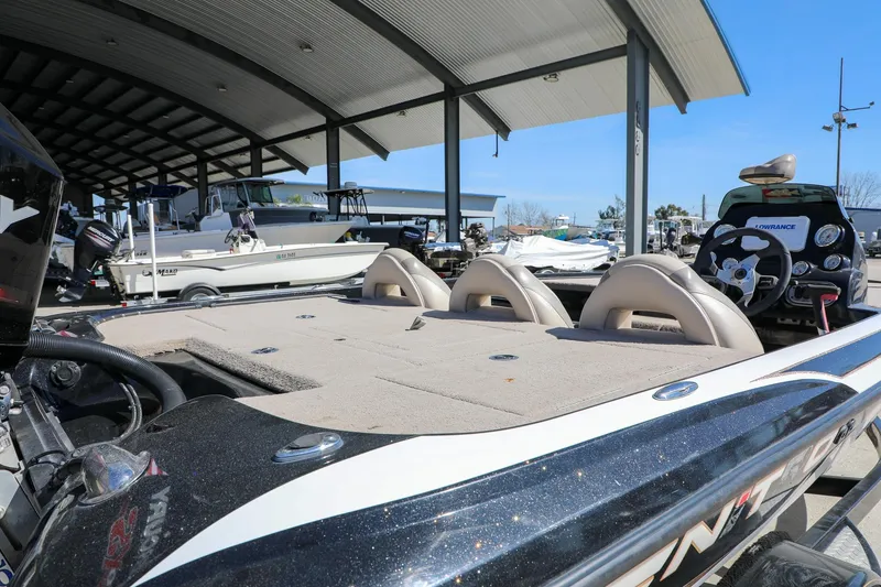 Slide: The Image of 2013 Nitro Z-7 boat in marina, featuring spacious deck and modern steering console. - 5
