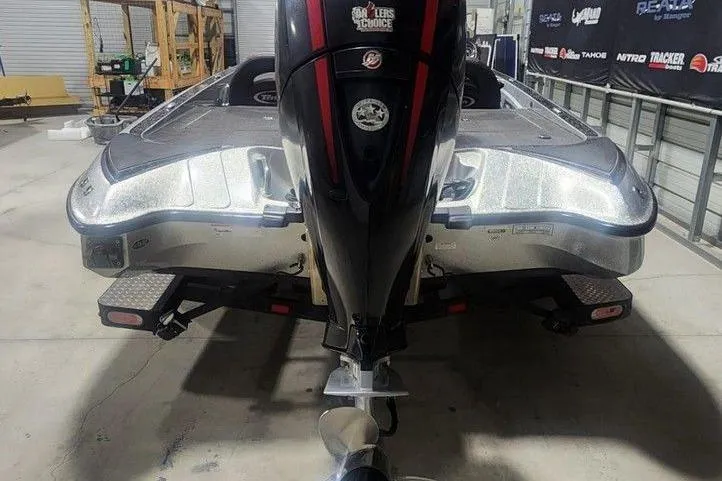 Slide: The Image of 2021 Triton 189 TrX boat with motor, parked indoors on a trailer. - 4