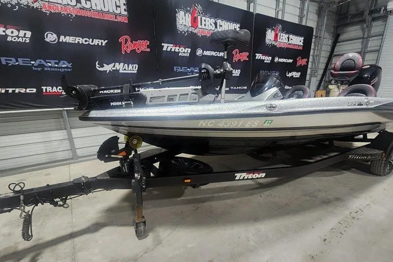 Slide: The Image of 2021 Triton 189 TrX boat on trailer in showroom with promotional banners. - 5