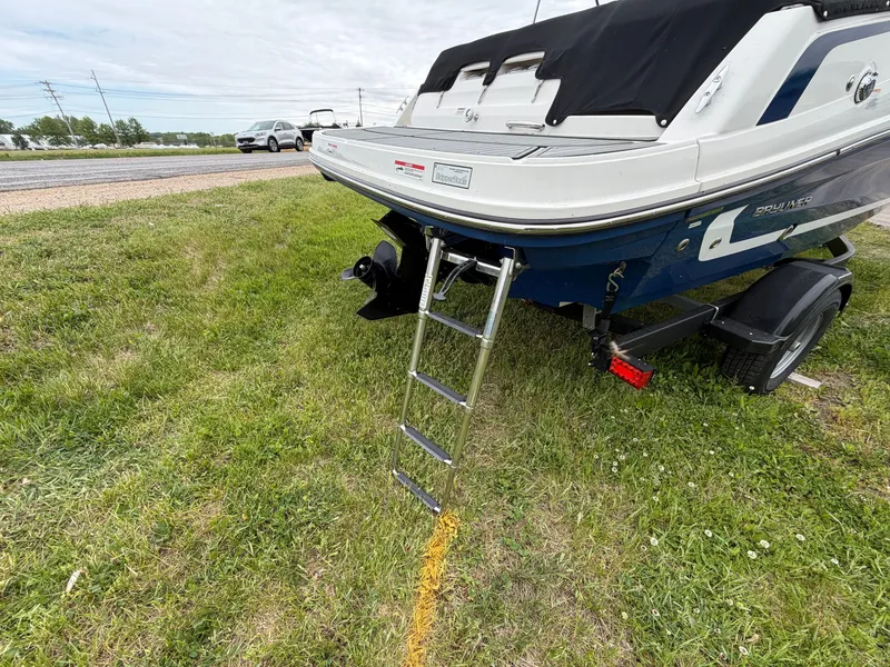 Slide: The Image of 2019 Bayliner V45 boat with ladder parked on grass. - 11