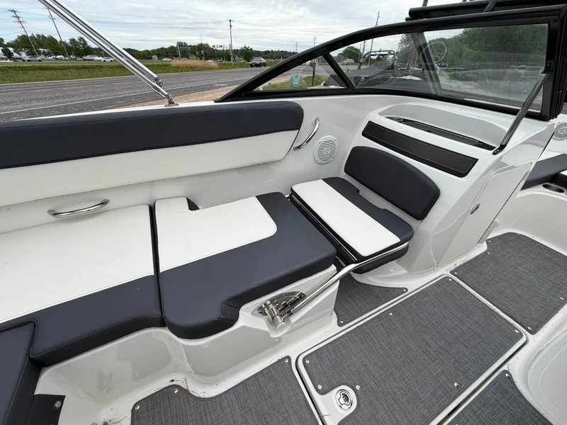 Slide: The Image of Interior of a 2019 Bayliner V45 boat with gray and white seating. - 25