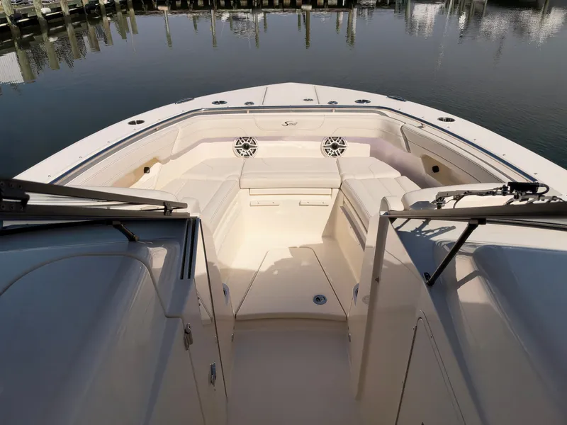 Slide: The Image of The image shows the bow area of a Scout 288 Dorado boat with beige seating. - 43