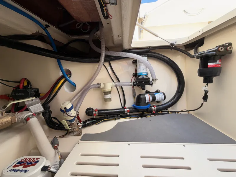 Slide: The Image of A view inside the engine compartment of a 2027 Scout 288 Dorado, featuring various hoses and pumps. - 13