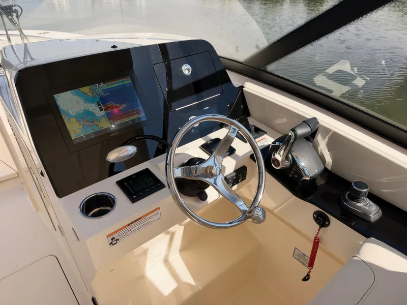 Slide: The Image of The image shows the helm of a Scout 288 Dorado boat with modern navigation instruments. - 30