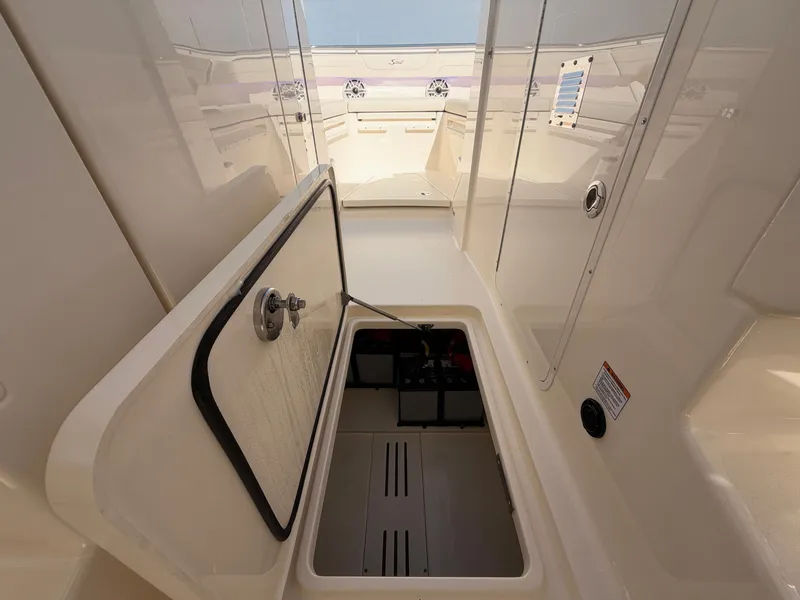 Slide: The Image of An open storage compartment on a 2027 Scout 288 Dorado boat. - 42