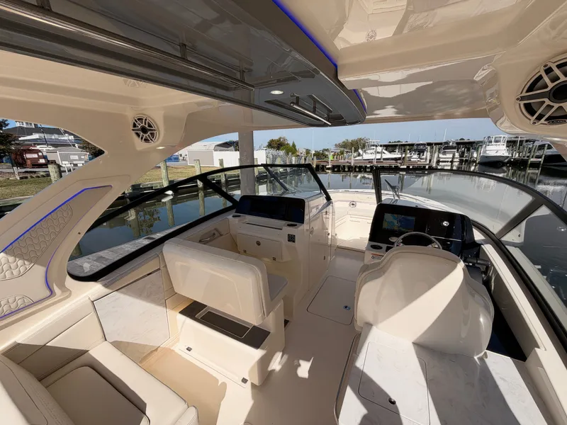 Slide: The Image of The image shows the cockpit of a 2027 Scout 288 Dorado boat with luxurious seating and modern electronics. - 26