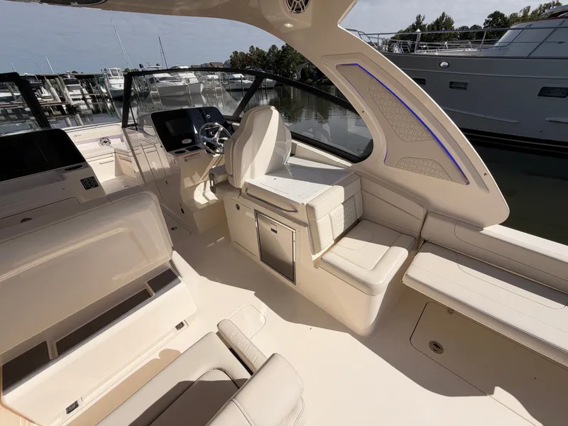 Slide: The Image of The image shows the cockpit of a 2027 Scout 288 Dorado boat with sleek seating and modern features. - 24