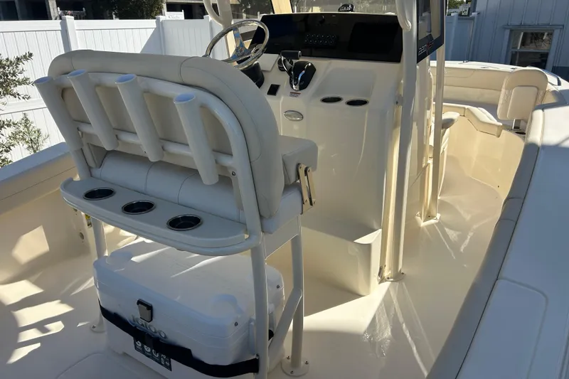 Slide: The Image of 2026 Scout 220 XSF boat interior with helm, seating, and storage cooler. - 14