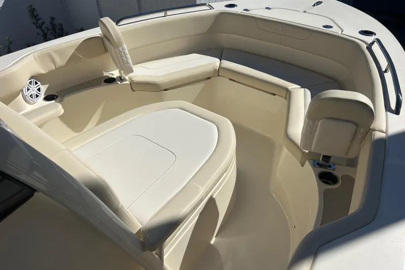 Slide: The Image of 2026 Scout 220 XSF boat interior with beige seating and cup holders. - 15