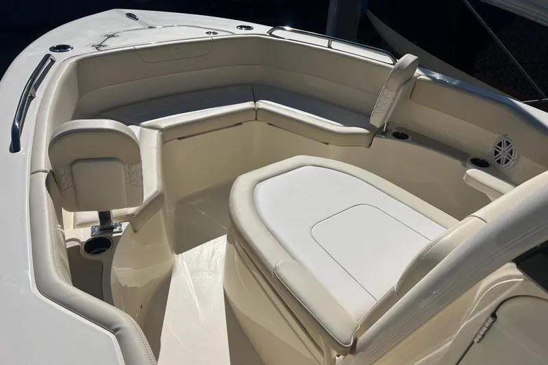 Slide: The Image of 2026 Scout 220 XSF boat interior with cushioned seating and cup holders. - 16