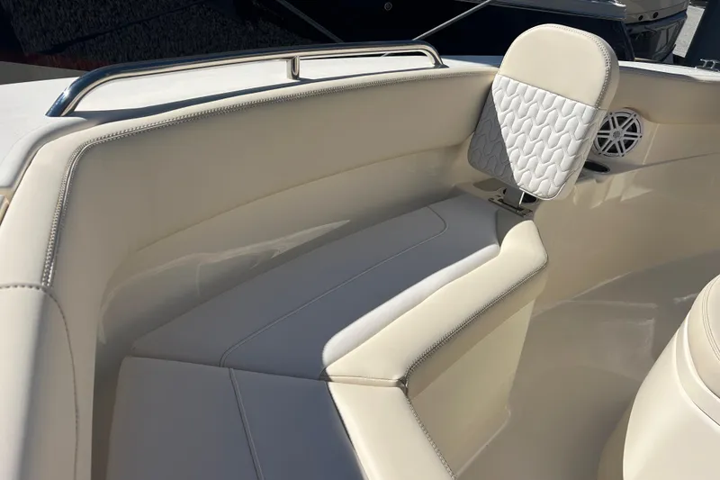 Slide: The Image of 2026 Scout 220 XSF boat interior with beige seating and speaker detail. - 18