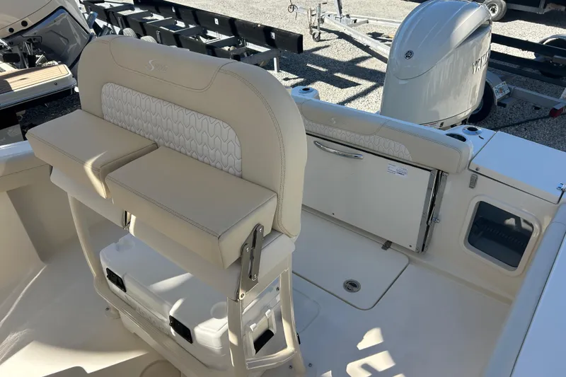 Slide: The Image of 2026 Scout 220 XSF boat interior with beige seating and storage compartments. - 20