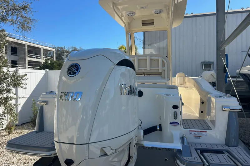 Slide: The Image of 2026 Scout 220 XSF boat with Yamaha 200 engine, docked outdoors. - 5