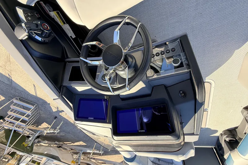 Slide: The Image of 2026 Avalon 2585 Excalibur LTD boat dashboard with steering wheel and control panels. - 25