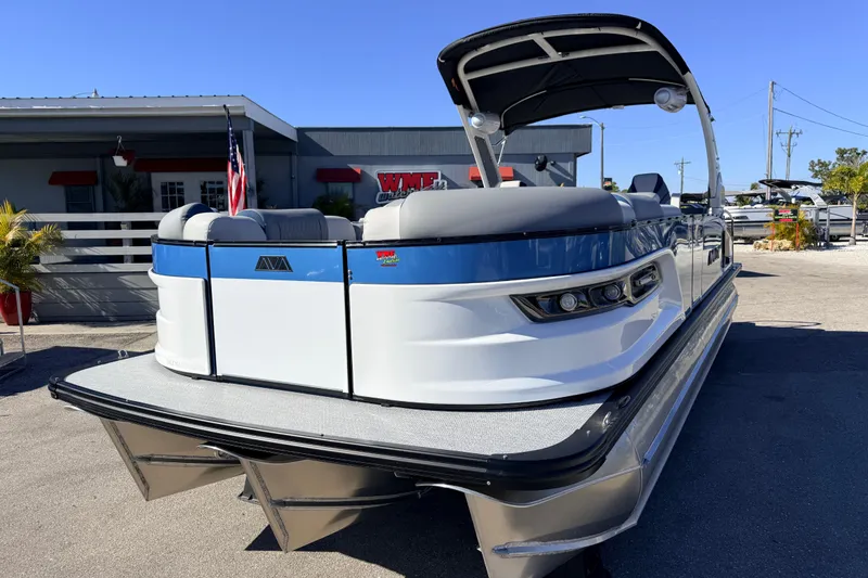 Slide: The Image of 2026 Avalon 2585 Excalibur LTD Flex Lounge Tri Toon boat, high performance, docked outdoors. - 3