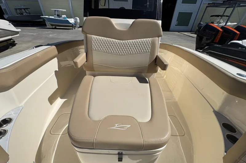 Slide: The Image of 2025 Scout 260 LXF boat interior with beige seating and armrests. - 12