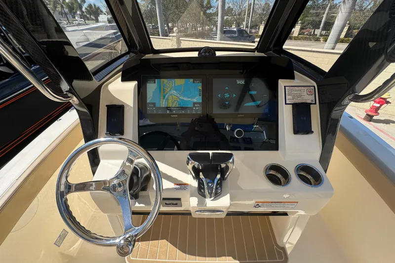 Slide: The Image of 2025 Scout 260 LXF boat dashboard with advanced navigation system and steering wheel. - 16