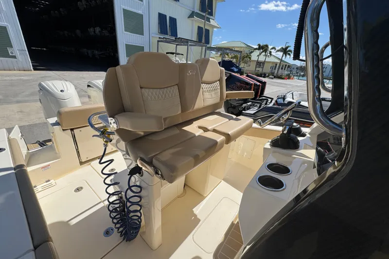 Slide: The Image of 2025 Scout 260 LXF boat interior with beige seating and modern controls. - 21