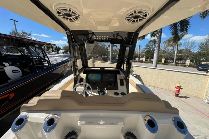 Slide: The Image of 2025 Scout 260 LXF boat interior with steering wheel and navigation system. - 25
