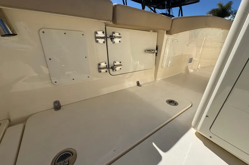 Slide: The Image of 2025 Scout 260 LXF boat interior with storage compartments and seating area. - 26