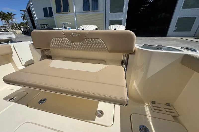 Slide: The Image of 2025 Scout 260 LXF boat interior with beige seating and storage compartments. - 28
