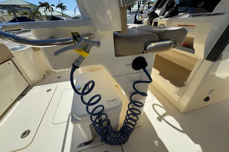 Slide: The Image of 2025 Scout 260 LXF boat interior with coiled hose and seating area. - 30