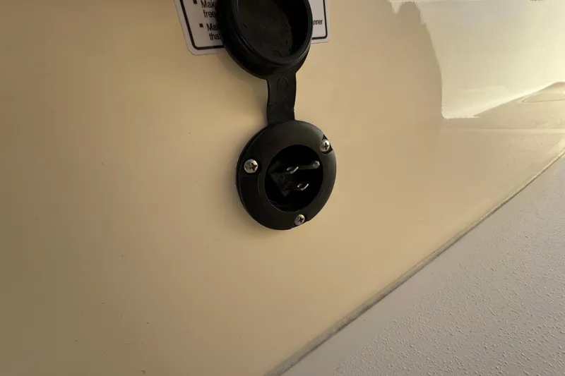 Slide: The Image of 2025 Scout 260 LXF boat power outlet on beige surface. - 34