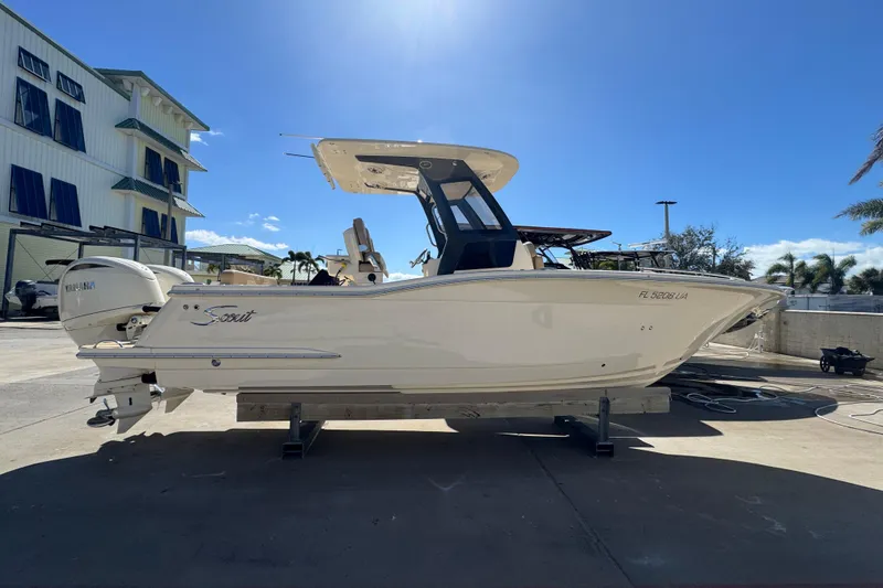 Slide: The Image of 2025 Scout 260 LXF boat on display, side view, sunny day. - 8