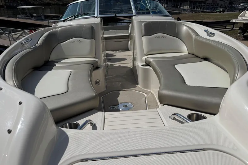 Slide: The Image of 2006 Sea Ray 240 Sundeck interior with spacious seating and cup holders. - 11