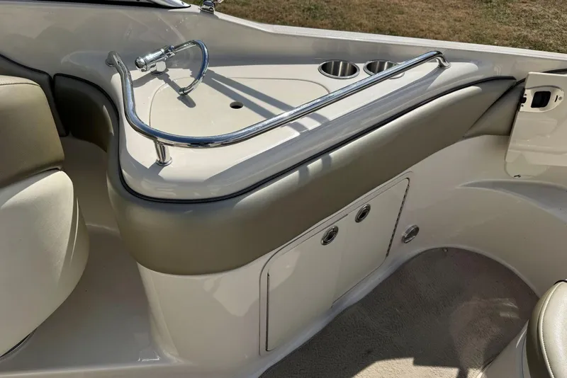 Slide: The Image of 2006 Sea Ray 240 Sundeck interior with sink and cup holders. - 16