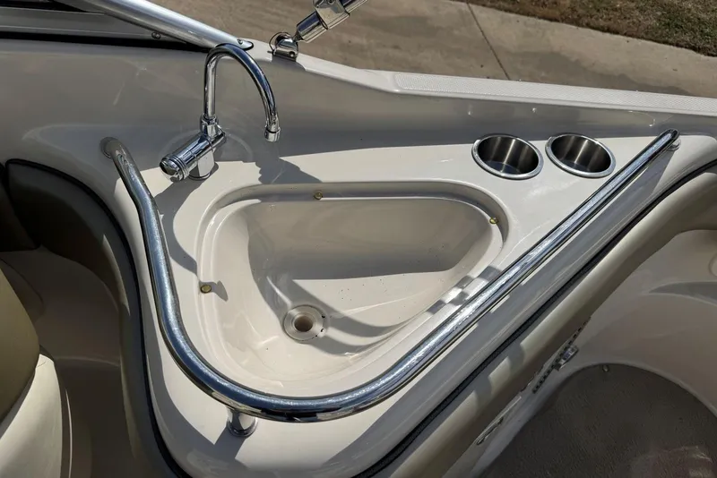 Slide: The Image of 2006 Sea Ray 240 Sundeck sink with faucet and cup holders on deck. - 17