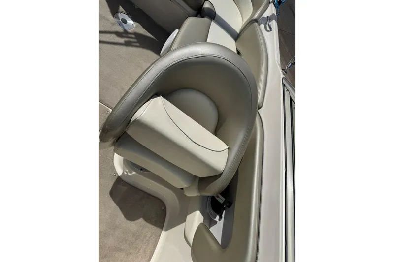 Slide: The Image of 2006 Sea Ray 240 Sundeck boat interior with cushioned seating. - 22