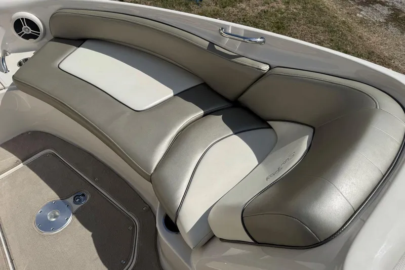 Slide: The Image of 2006 Sea Ray 240 Sundeck boat interior with cushioned seating and speaker. - 24