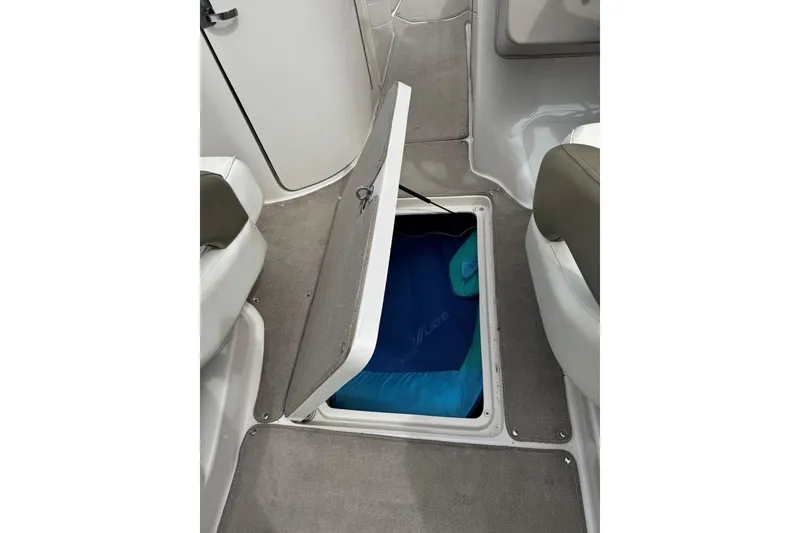 Slide: The Image of Open storage compartment on 2006 Sea Ray 240 Sundeck boat interior. - 30