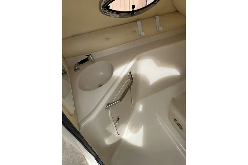 Slide: The Image of 2006 Sea Ray 240 Sundeck interior with sink and storage compartment. - 33