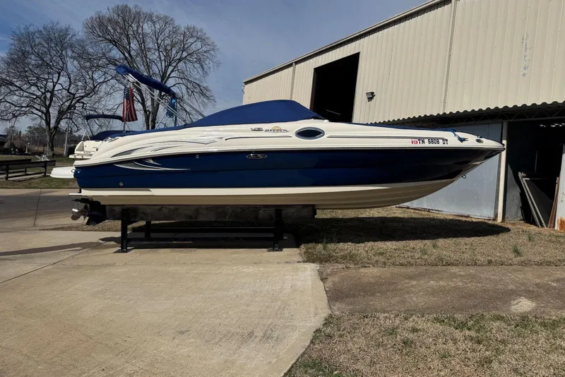Slide: The Image of 2006 Sea Ray 240 Sundeck boat on display outside a storage building. - 43