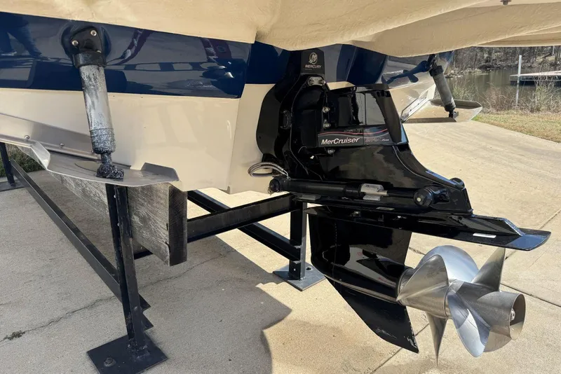 Slide: The Image of 2006 Sea Ray 240 Sundeck with MerCruiser engine, displayed on a boat lift. - 44