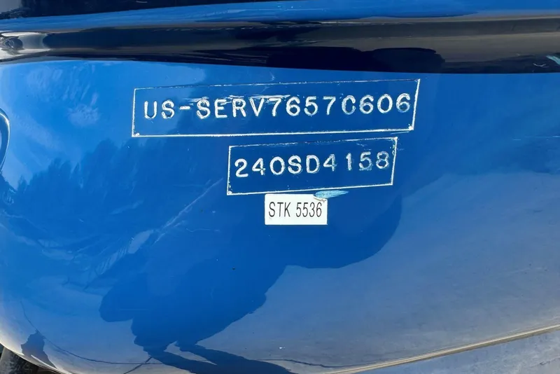 Slide: The Image of 2006 Sea Ray 240 Sundeck boat identification numbers on blue hull. - 46